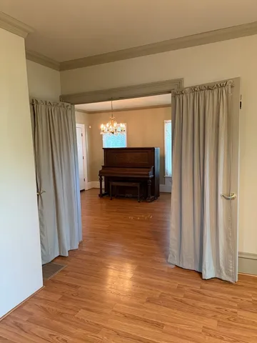 a view of room with window and wooden floor