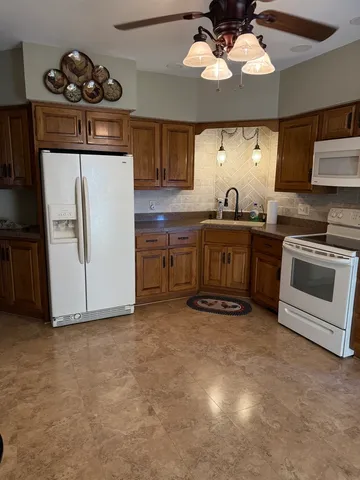 a kitchen with stainless steel appliances granite countertop a stove and a refrigerator