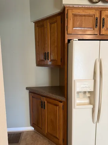 a kitchen with a refrigerator and cabinets