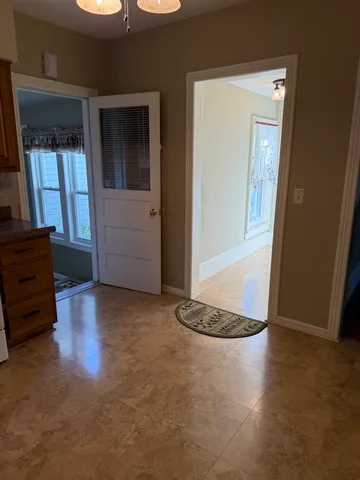a view of a livingroom with wooden floor and a window