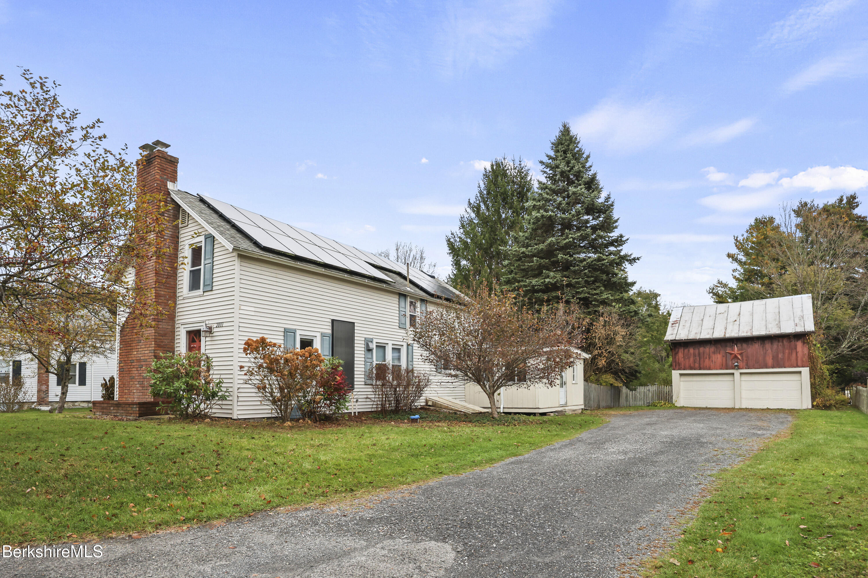 a front view of house with a garden