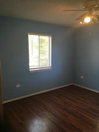 a view of a room with wooden floor and windows in it