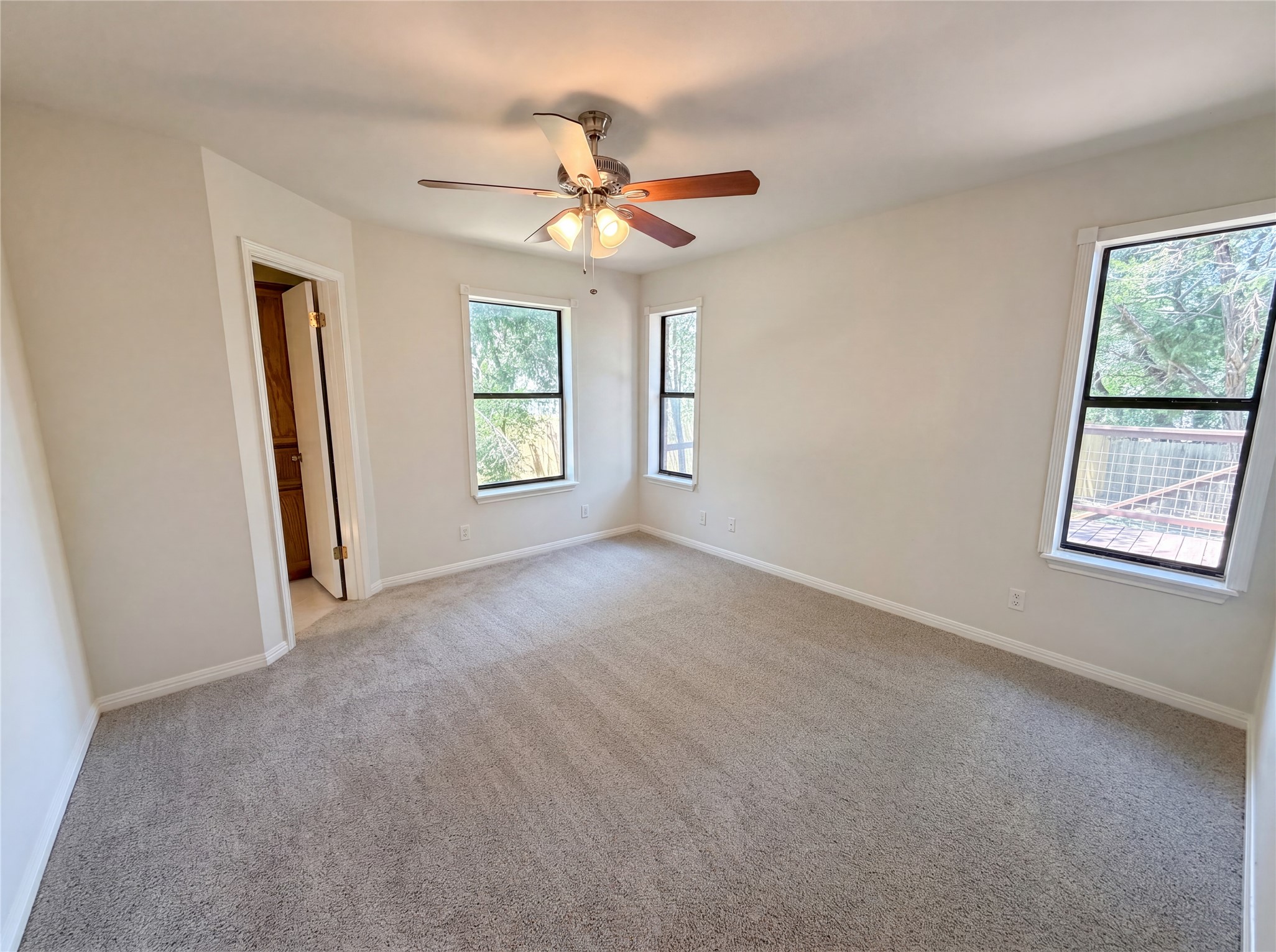 1111 North Riviera Circle Cedar Park, TX 78613 - Photo 10 of 17 Carpeted interior space featuring a ceiling fan with integrated lighting, two windows with black frames, and neutral wall tones