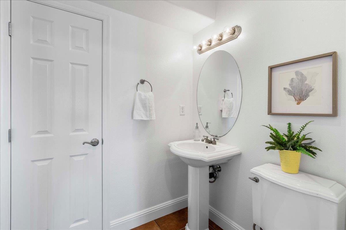 953 Winsford Court San Ramon, CA 94583 - Photo 31 of 73 a bathroom with a sink a mirror and a vase of flowers