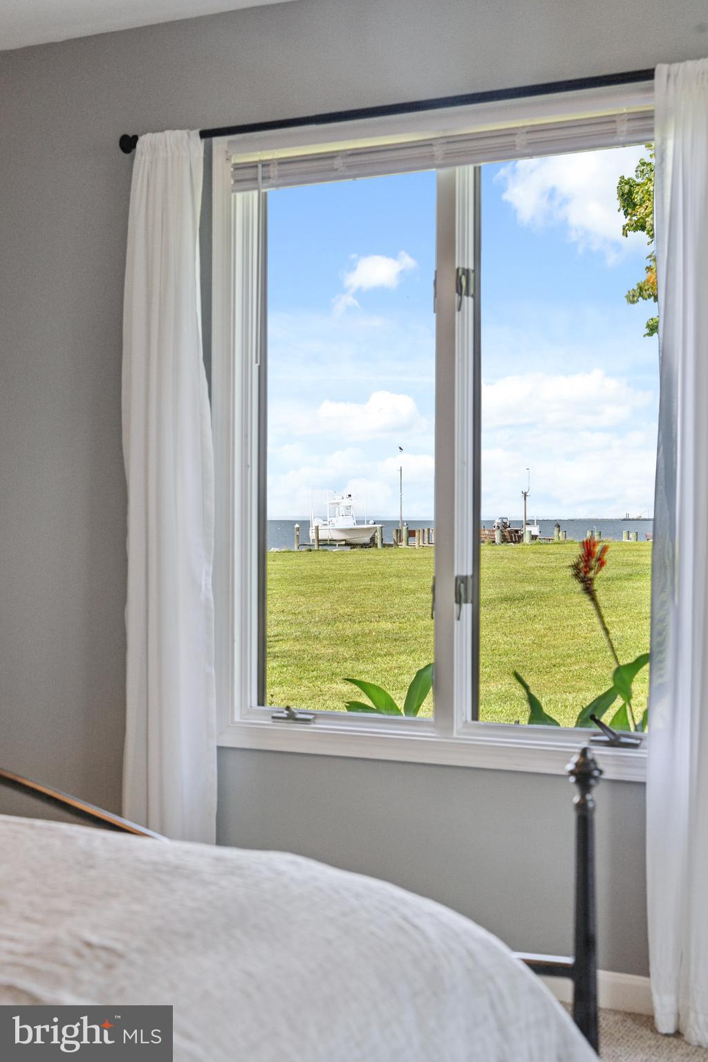 2554 Hoopers Island Road Fishing Creek, MD 21634 - Photo 11 of 85 a view of a room with wooden floor and windows