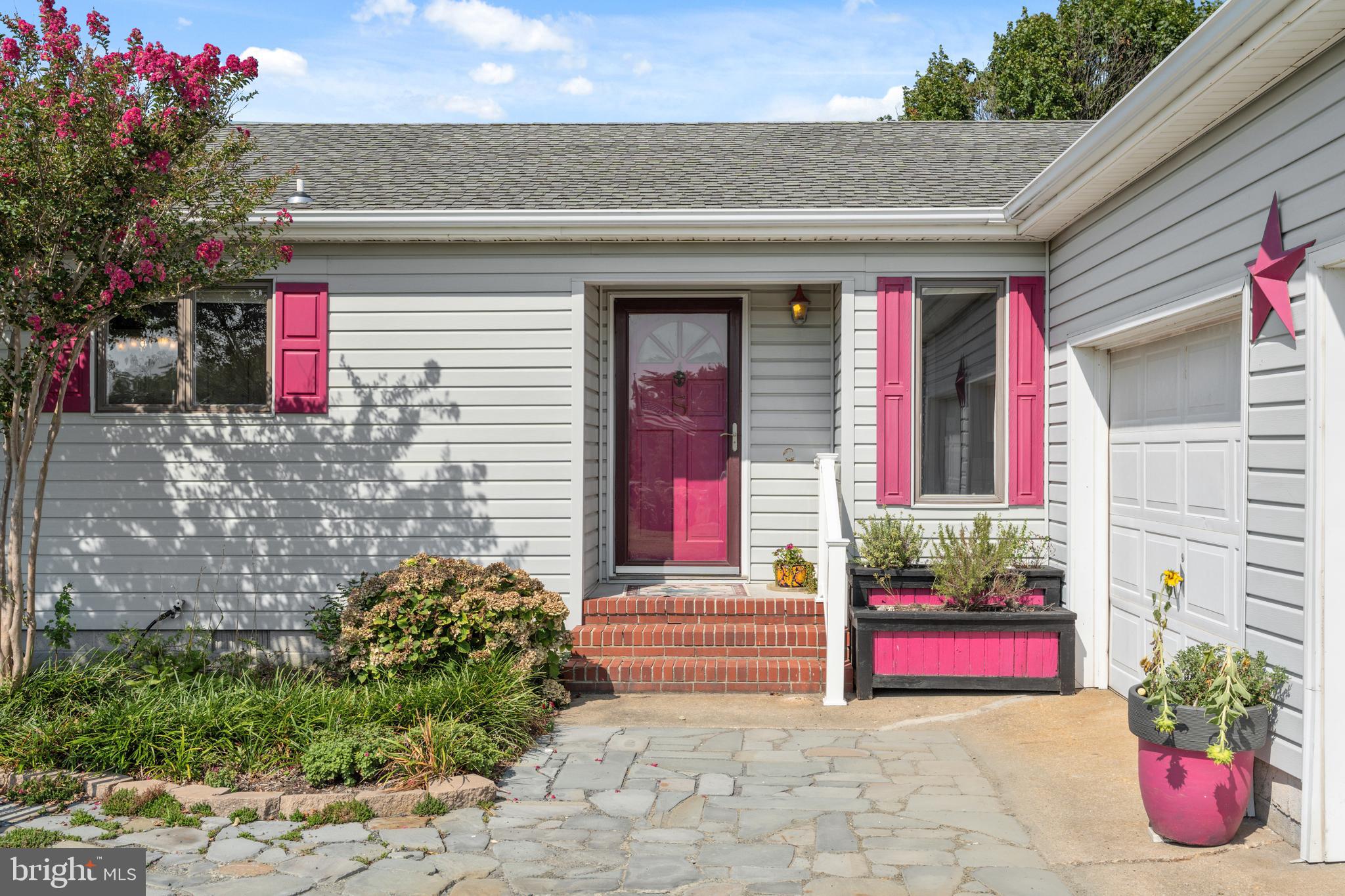 2554 Hoopers Island Road Fishing Creek, MD 21634 - Photo 18 of 85 a front view of a house with lots of flowers