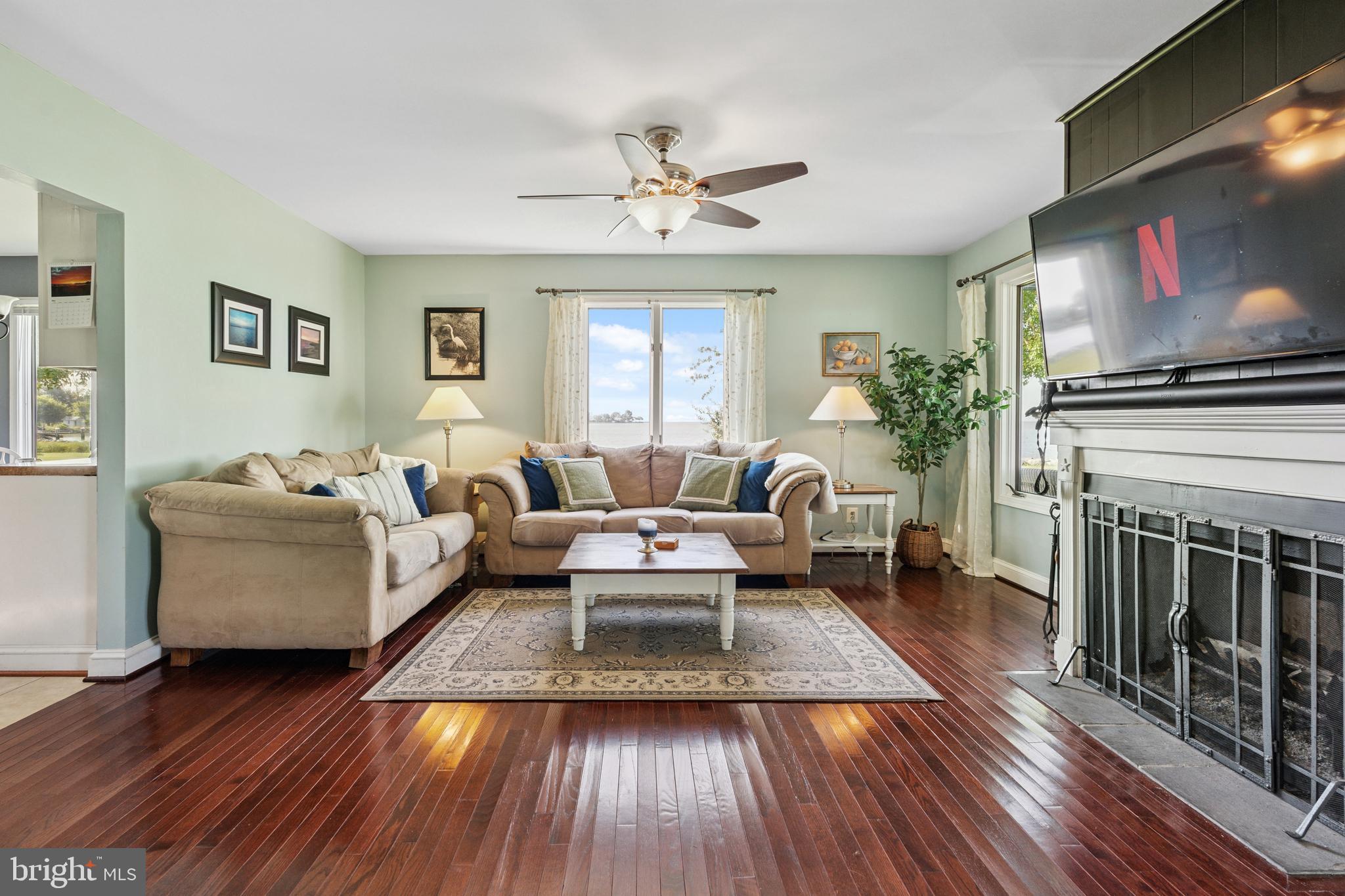 2554 Hoopers Island Road Fishing Creek, MD 21634 - Photo 23 of 85 a living room with furniture a fireplace and a flat screen tv