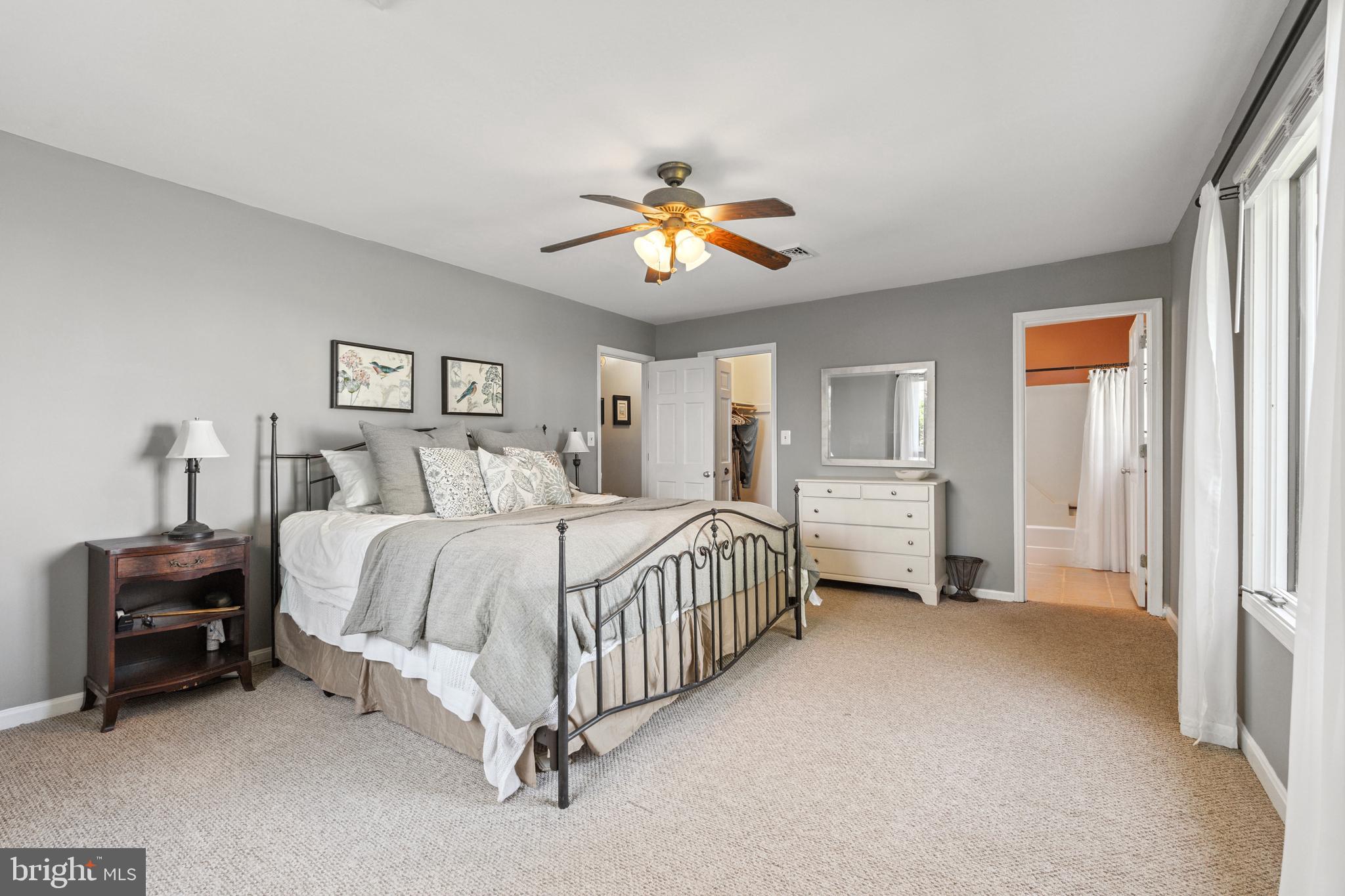 2554 Hoopers Island Road Fishing Creek, MD 21634 - Photo 36 of 85 a spacious bedroom with a bed and a chandelier