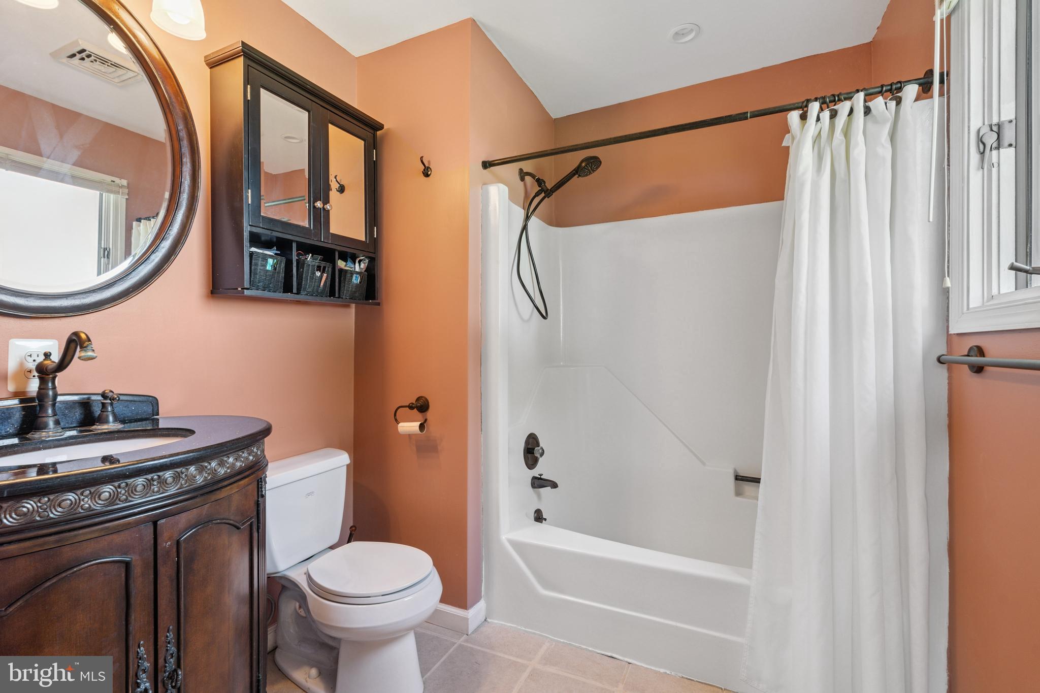 2554 Hoopers Island Road Fishing Creek, MD 21634 - Photo 39 of 85 a bathroom with a sink a toilet and a mirror