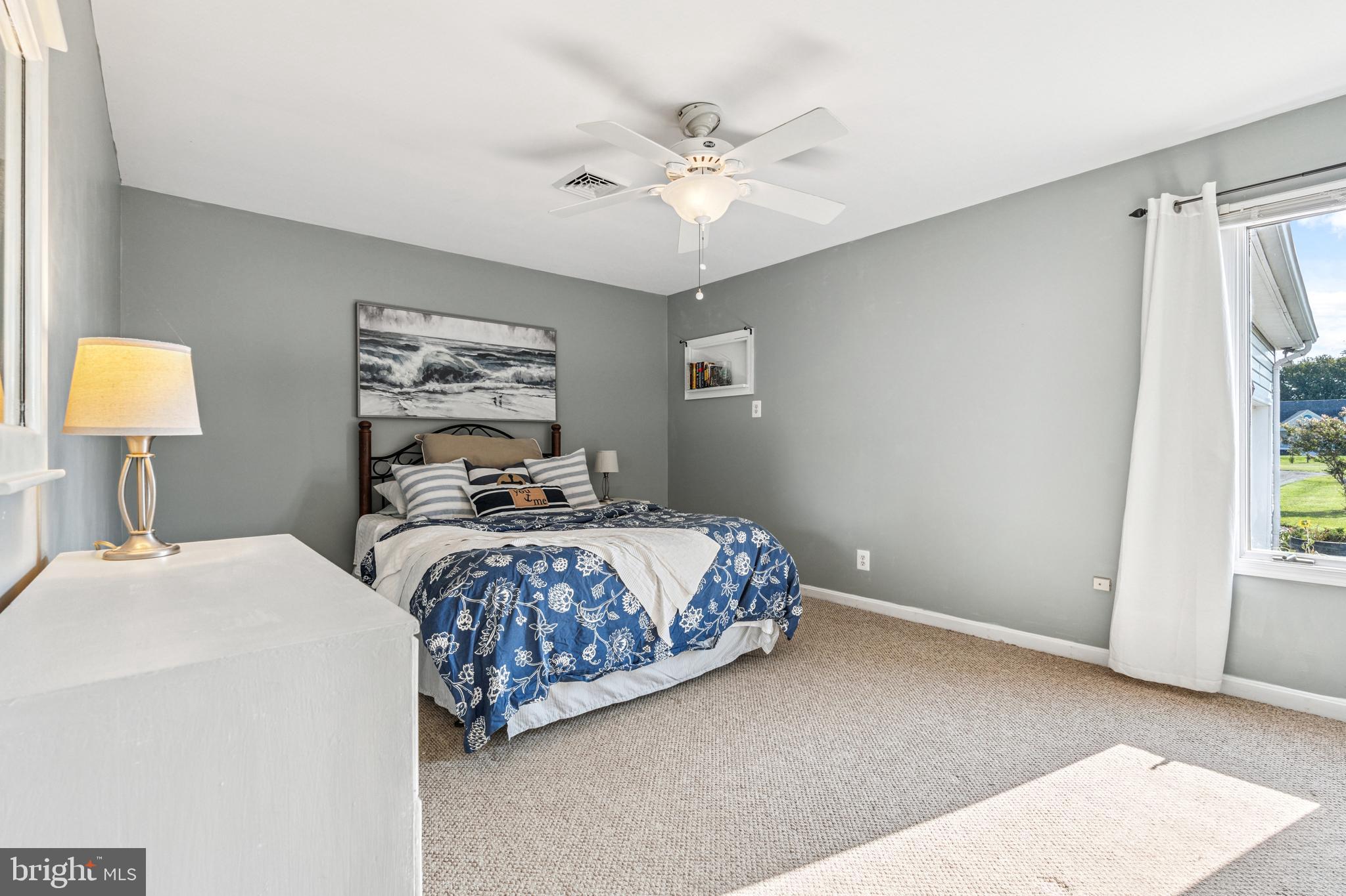 2554 Hoopers Island Road Fishing Creek, MD 21634 - Photo 43 of 85 a bedroom with a bed and a chandelier