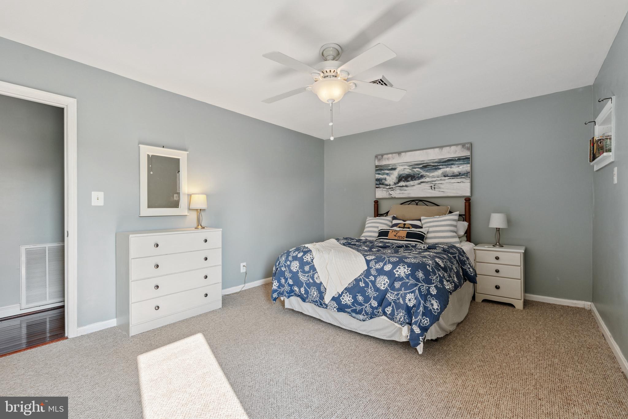 2554 Hoopers Island Road Fishing Creek, MD 21634 - Photo 45 of 85 a bedroom with a bed and a chandelier