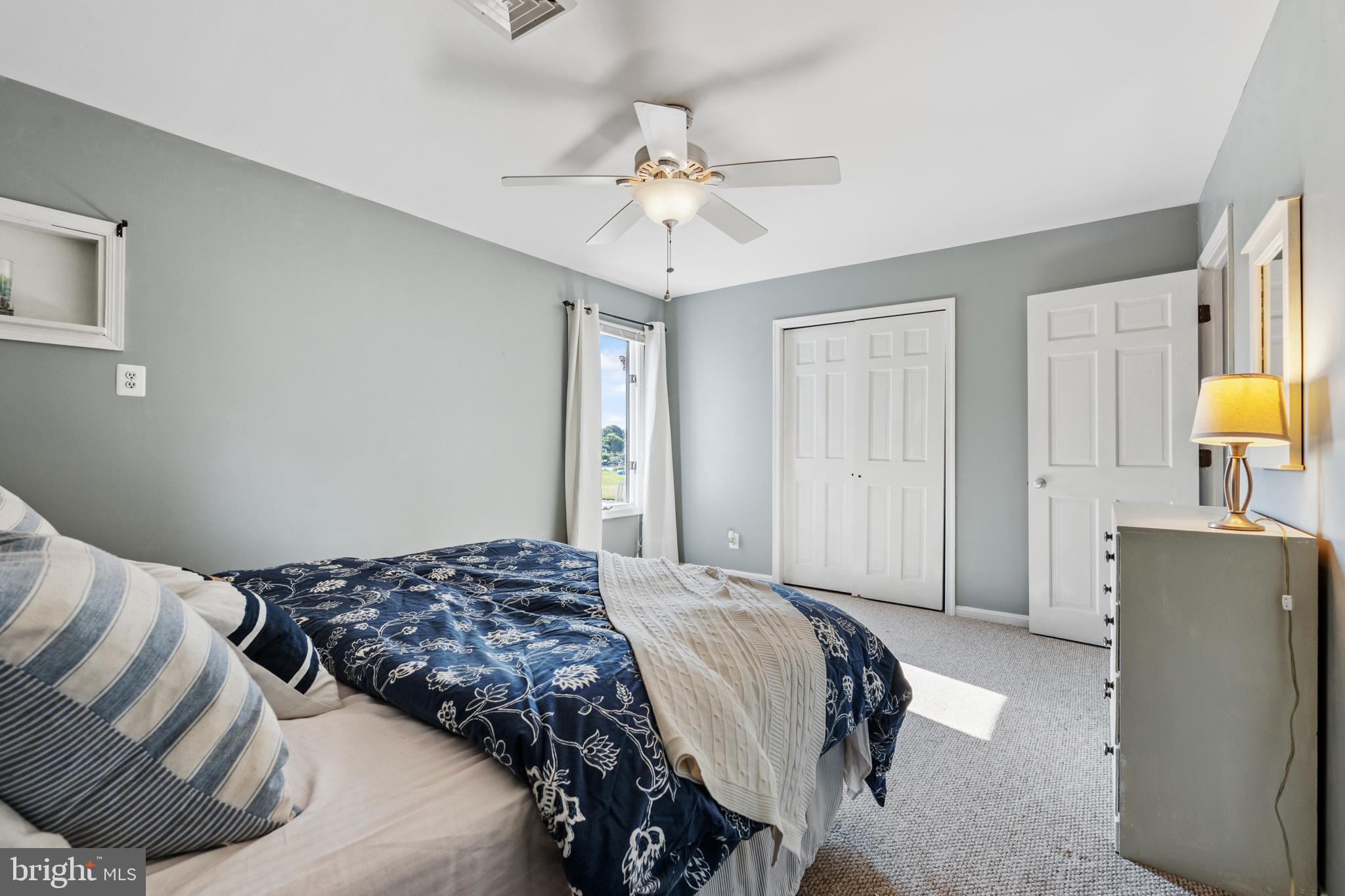 2554 Hoopers Island Road Fishing Creek, MD 21634 - Photo 46 of 85 a bedroom with a bed and a chandelier