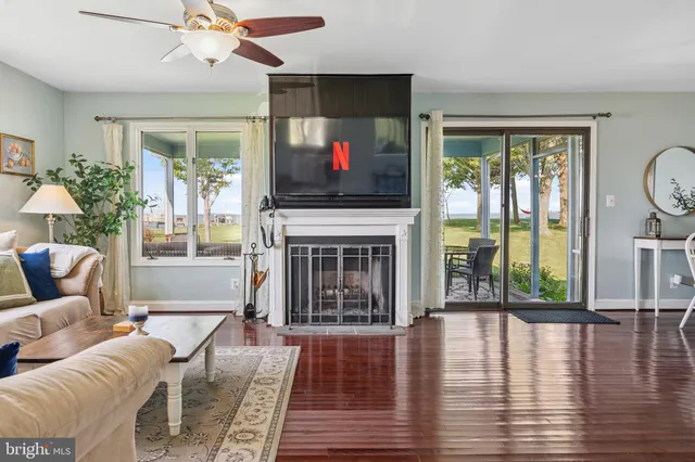 a view of ocean with boats and trees in all around
