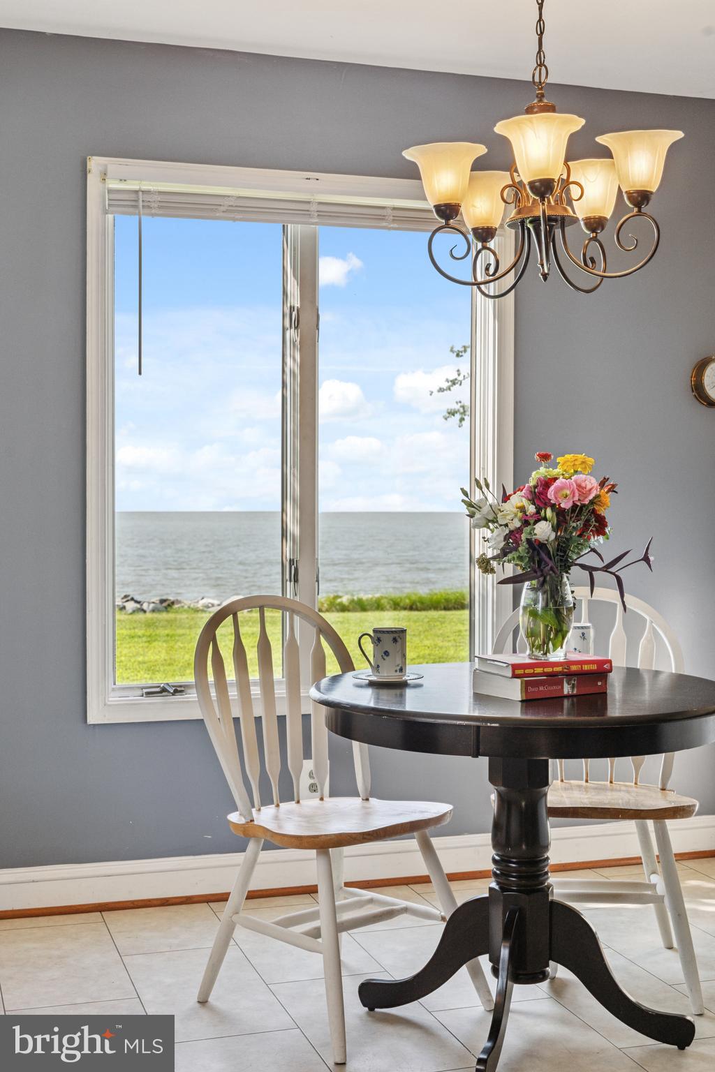 2554 Hoopers Island Road Fishing Creek, MD 21634 - Photo 10 of 85 a view of a dining room with furniture a chandelier and large windows
