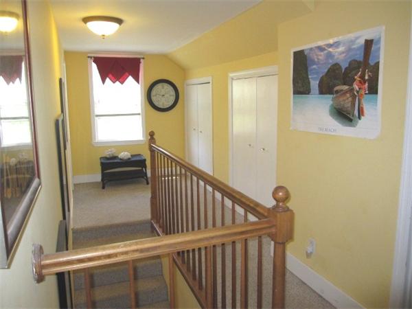 142 Haggetts Pond Road Andover, MA 01810 - Photo 17 of 21 a view of a hallway with wooden floor and windows