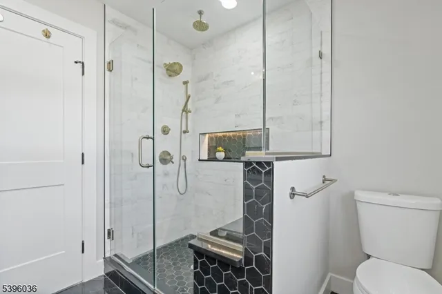a bathroom with a toilet and a shower
