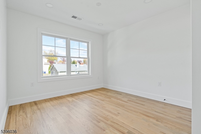 401 Tillman Street, Unit B Raritan, NJ 08869 - Photo 15 of 28 an empty room with wooden floor and windows