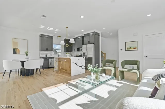 a living room with furniture and kitchen view