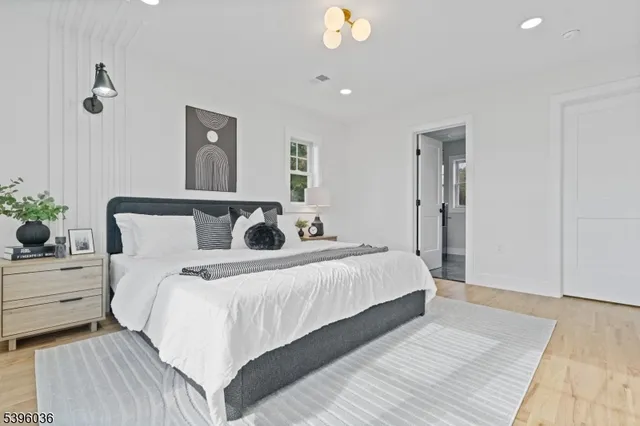 a bedroom with bed and a potted plant