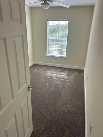 a view of an empty room with a window
