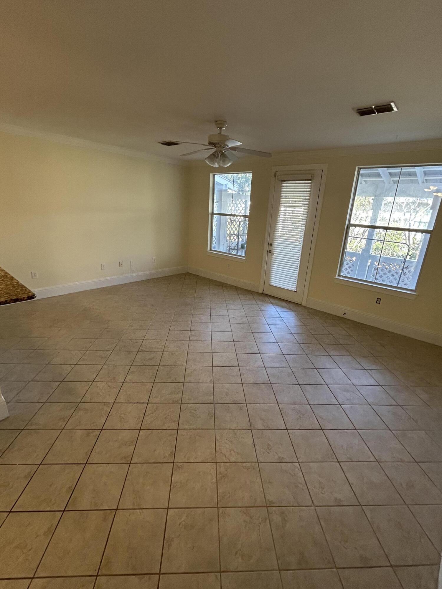 17 Bald Eagle Court, Unit 6G Santa Rosa Beach, FL 32459 - Photo 4 of 12 an empty room with windows and fireplace