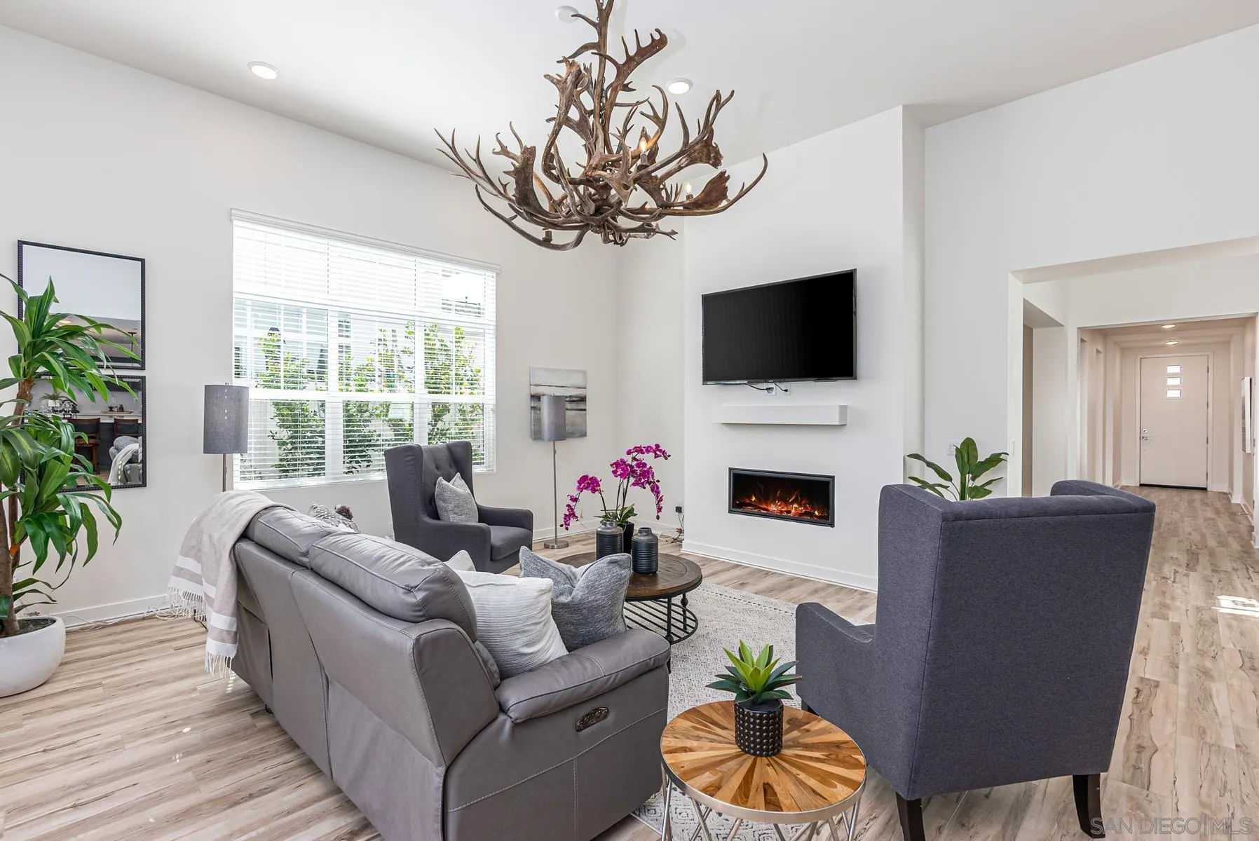 8855 Weston Road Santee, CA 92071 - Photo 11 of 36 a living room with furniture a fireplace and a flat screen tv