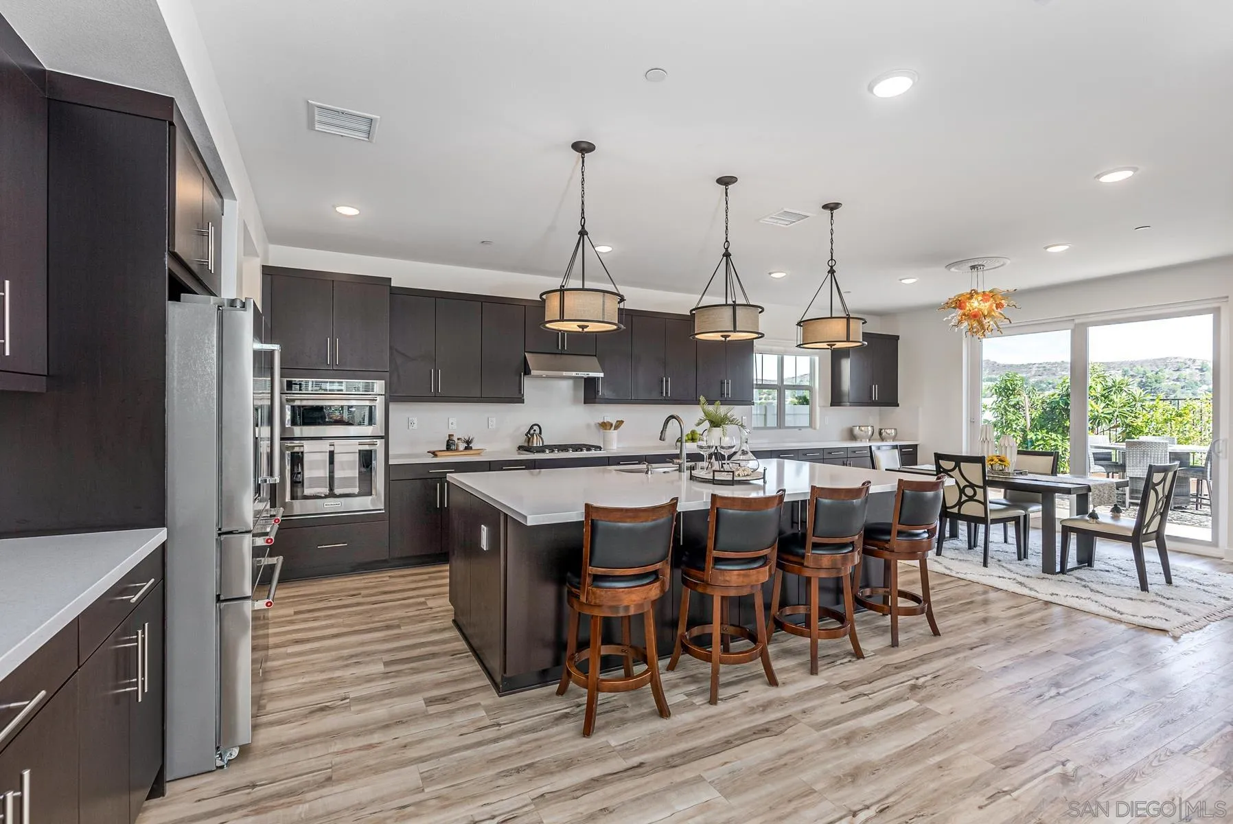 8855 Weston Road Santee, CA 92071 - Photo 12 of 36 a large kitchen with lots of counter space and dining table