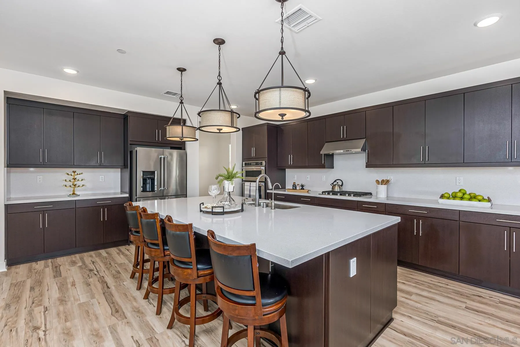 8855 Weston Road Santee, CA 92071 - Photo 13 of 36 a kitchen with a dining table chairs sink and cabinets