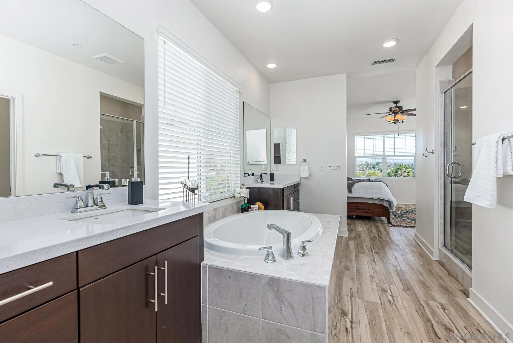 8855 Weston Road Santee, CA 92071 - Photo 22 of 36 a en suite bathroom with a double vanity sink a mirror and a shower