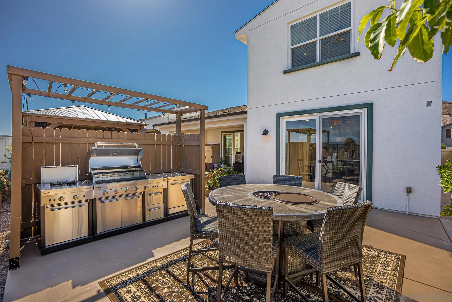 8855 Weston Road Santee, CA 92071 - Photo 29 of 36 a kitchen with granite countertop a table chairs stove and cabinets