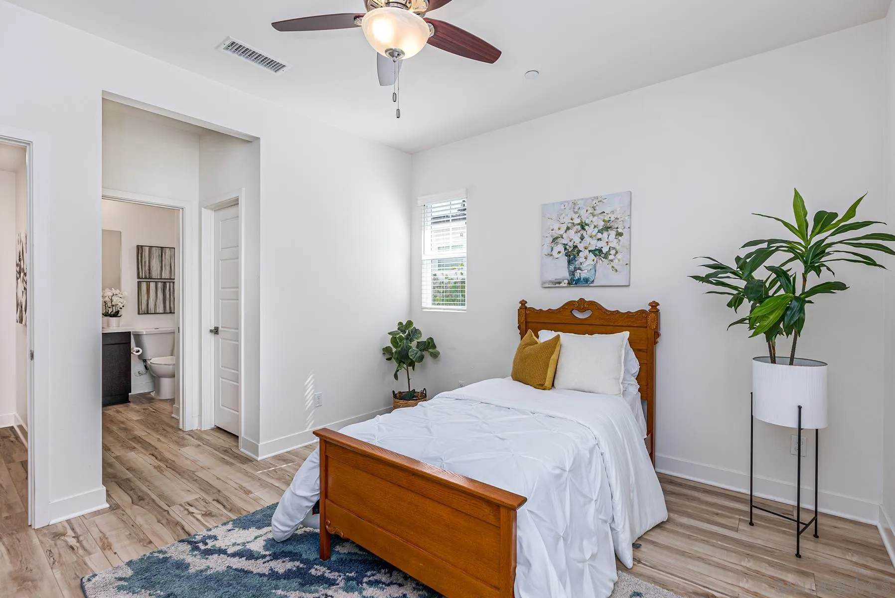 8855 Weston Road Santee, CA 92071 - Photo 6 of 36 a bedroom with a large bed and a chandelier