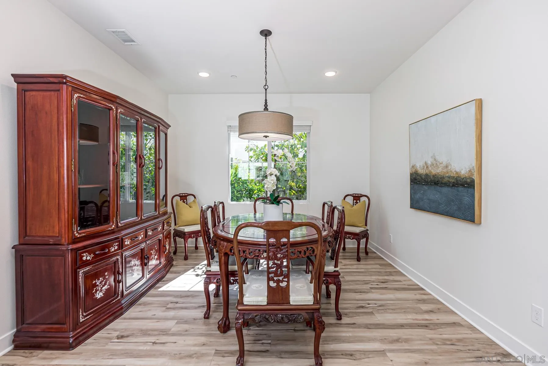 8855 Weston Road Santee, CA 92071 - Photo 7 of 36 a dining room with furniture a chandelier and wooden floor
