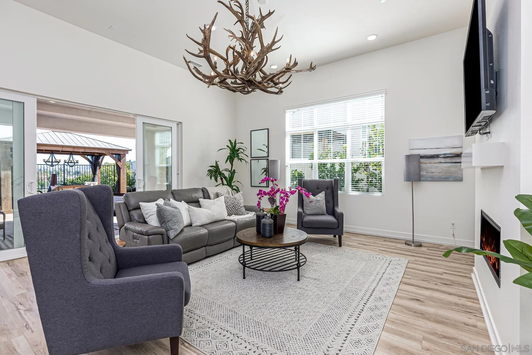 8855 Weston Road Santee, CA 92071 - Photo 9 of 36 a living room with furniture a flat screen tv and a chandelier