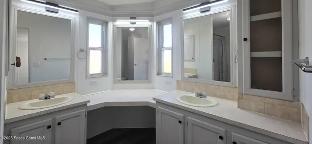 a bathroom with a sink double vanity and a mirror