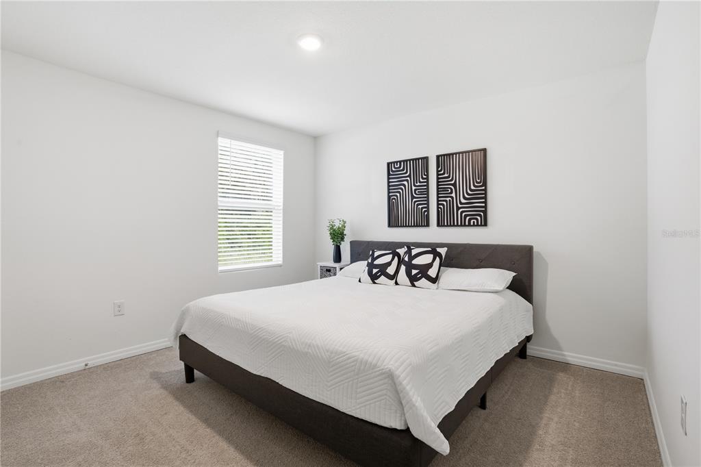 6761 Southeast 3rd Loop Ocala, FL 34472 - Photo 13 of 32 a bedroom with a bed and a night stand