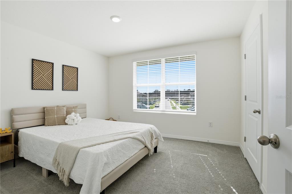 6761 Southeast 3rd Loop Ocala, FL 34472 - Photo 20 of 32 a bedroom with a bed and a window