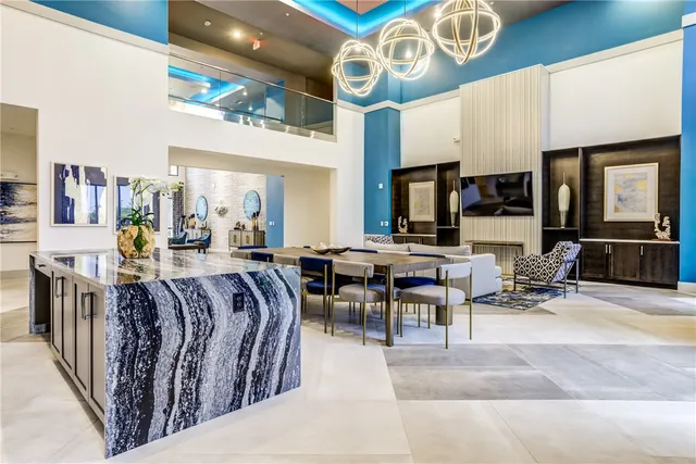 a view of kitchen with kitchen island wooden floor center island and stainless steel appliances