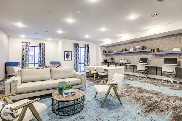 a large kitchen with stainless steel appliances a large counter top a stove a sink dishwasher and a refrigerator