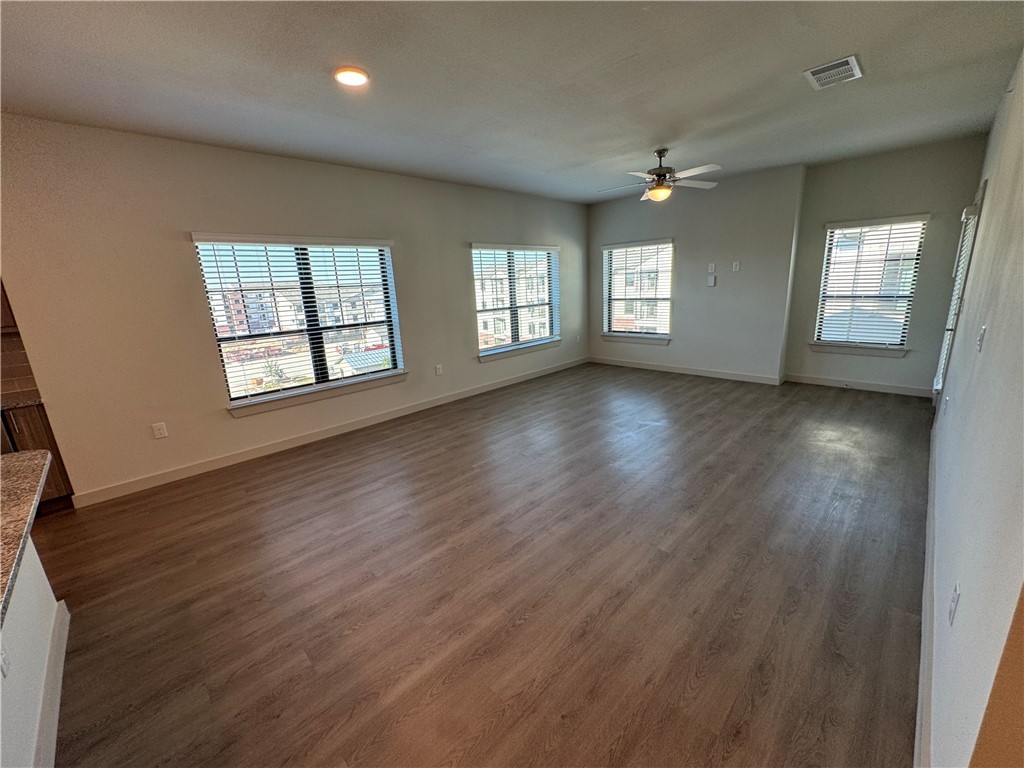 6000 Jones Road, Unit 4207 Bryan, TX 77807 - Photo 7 of 20 an empty room with wooden floor and windows