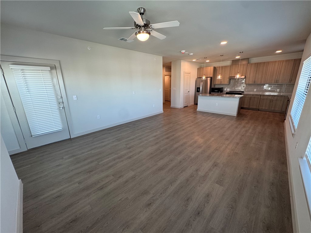 6000 Jones Road, Unit 4207 Bryan, TX 77807 - Photo 9 of 20 a view of kitchen with kitchen island wooden floor center island and stainless steel appliances