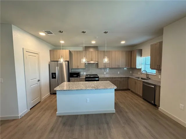 an empty room with closet and a chandelier fan