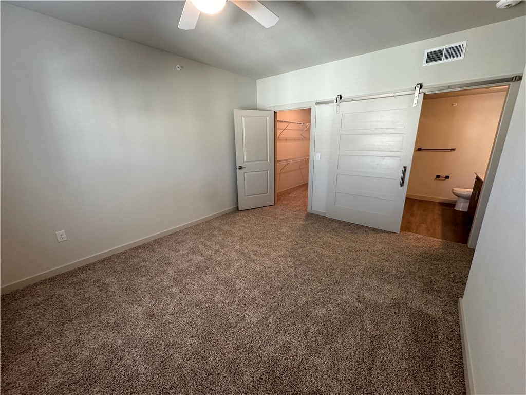 6000 Jones Road, Unit 4207 Bryan, TX 77807 - Photo 11 of 20 an empty room with closet and a chandelier fan