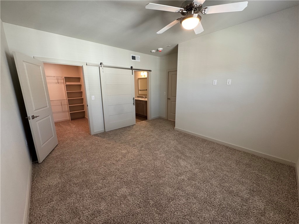 6000 Jones Road, Unit 4207 Bryan, TX 77807 - Photo 13 of 20 an empty room with closet and a ceiling fan