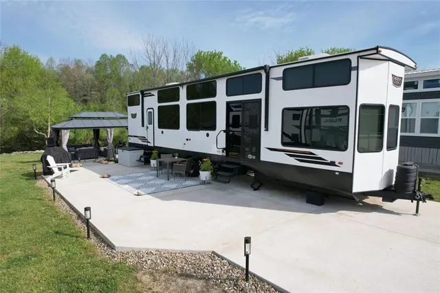 a view of a house with backyard and sitting area