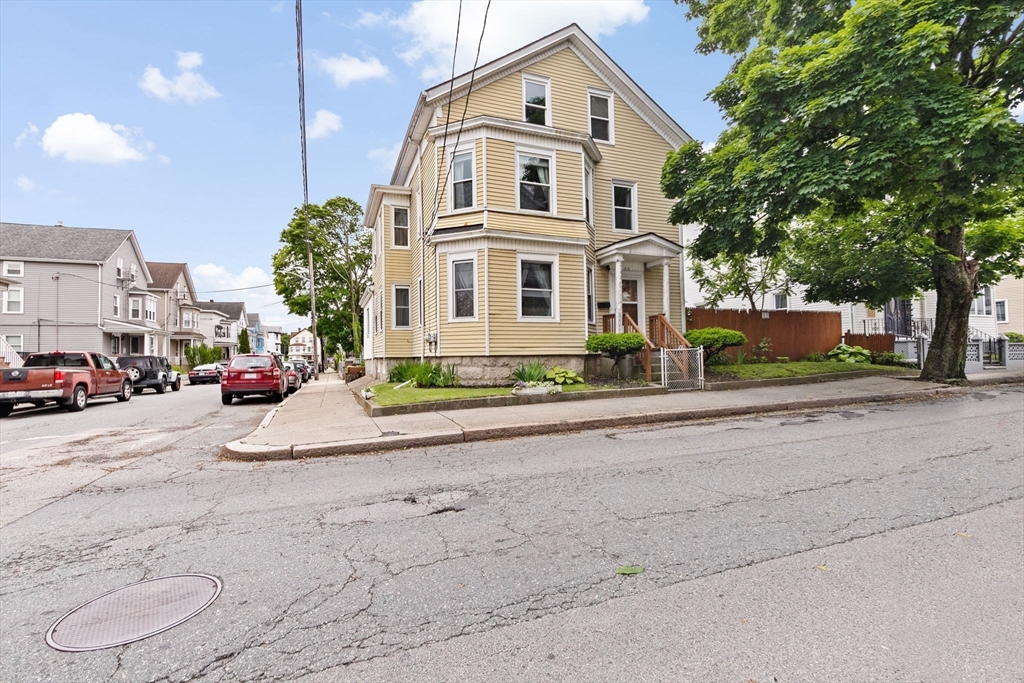 93 Warren Street Fall River, MA 02721 - Photo 1 of 42 a front view of a building with cars parked on road