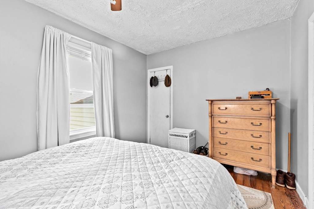 93 Warren Street Fall River, MA 02721 - Photo 12 of 42 a bedroom with a bed and a dresser