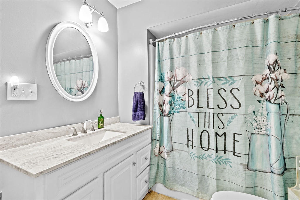 93 Warren Street Fall River, MA 02721 - Photo 16 of 42 a bathroom with a granite countertop sink and a mirror