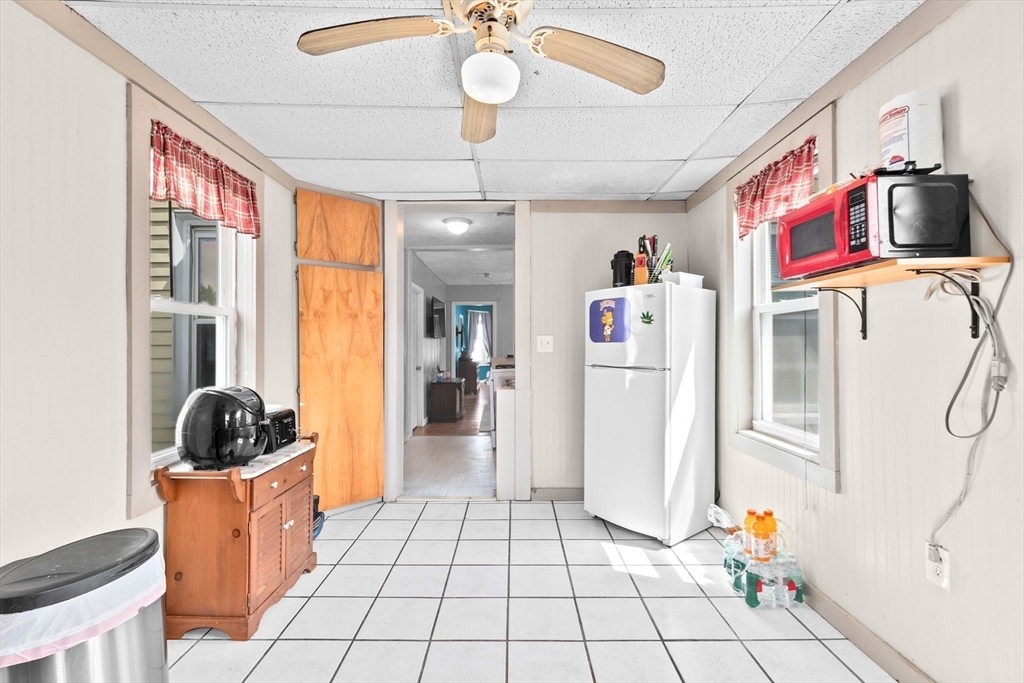 93 Warren Street Fall River, MA 02721 - Photo 20 of 42 a kitchen with a refrigerator and a stove