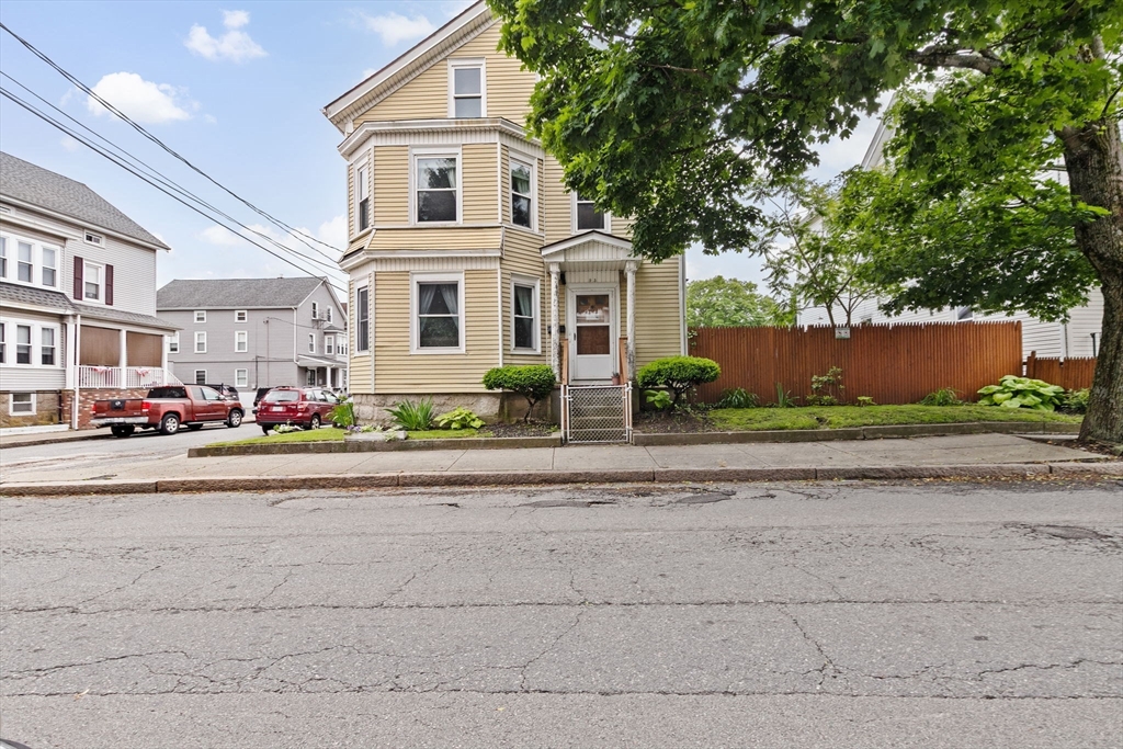 93 Warren Street Fall River, MA 02721 - Photo 2 of 42 a front view of a house with a yard and garage