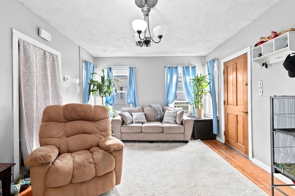 93 Warren Street Fall River, MA 02721 - Photo 22 of 42 a living room with furniture ceiling fan and a window